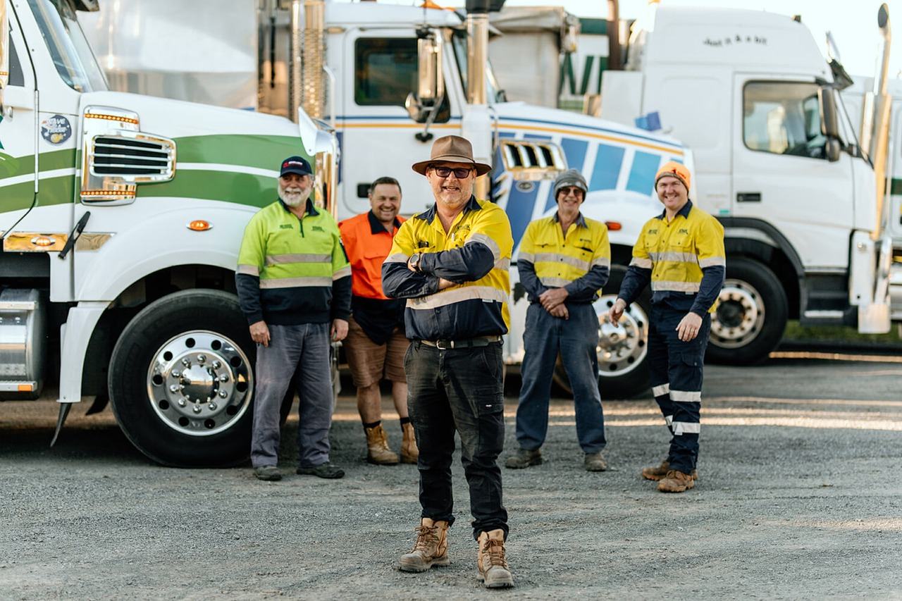 Drivers against the backdrop of trucks